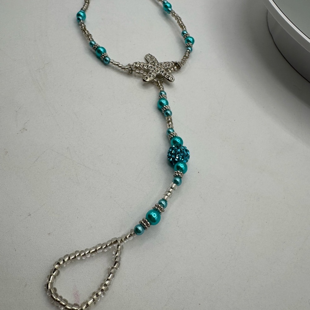 beat it bracelet with attached ring  Silver and Turquoise colored Beads starfish